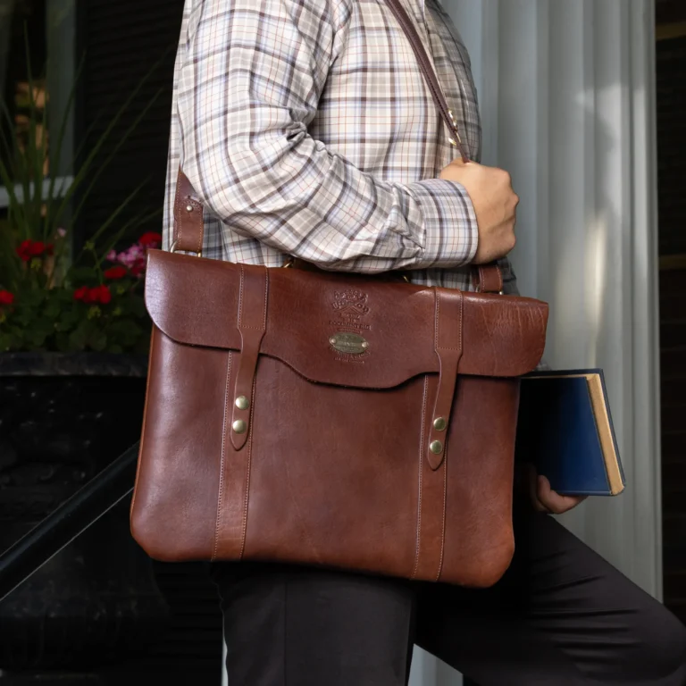 document bag with the strap on a man with a red shirt and holding a cup of coffee