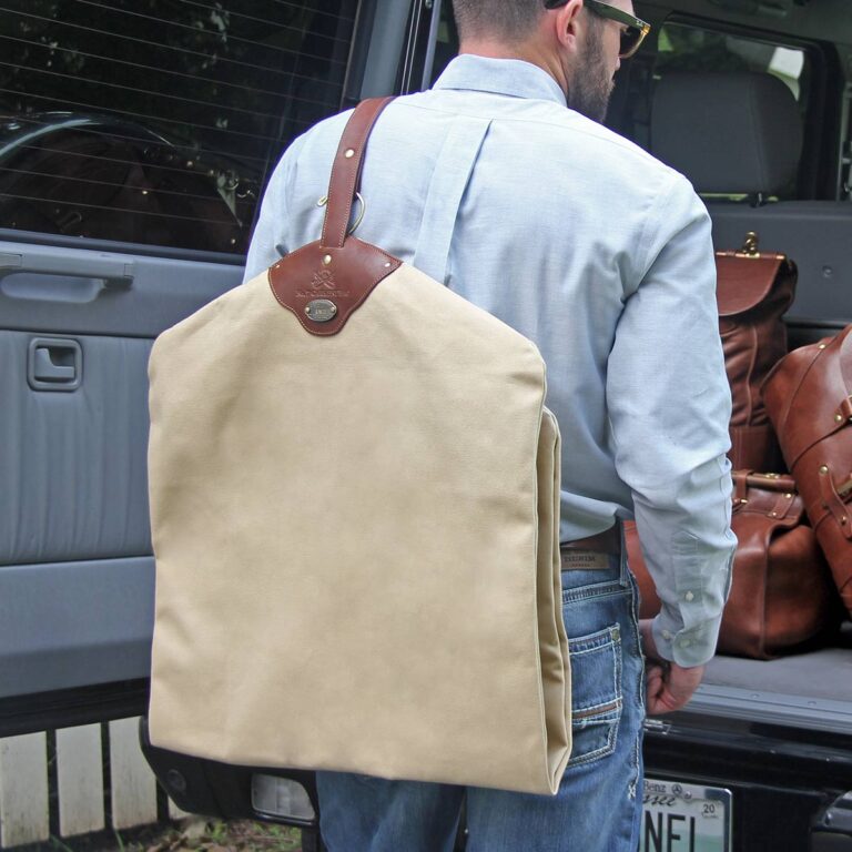 man holding a garment bag