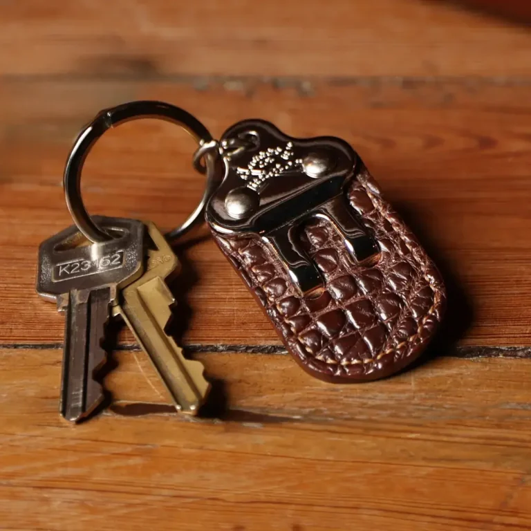 No. 3 Key Ring with 2-pronged metal hook and brown American Alligator Leather - front view with 2 keys on metal ring on a wood table