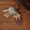 no 3 vintage brown leather key ring with keys on a wooden table