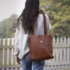 Girl holding the No. 9B Tote in Vintage Brown American Steerhide