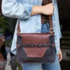 ashley handbag made of two-tone brown buffalo and steerhide leather - front view shown with a woman wearing it