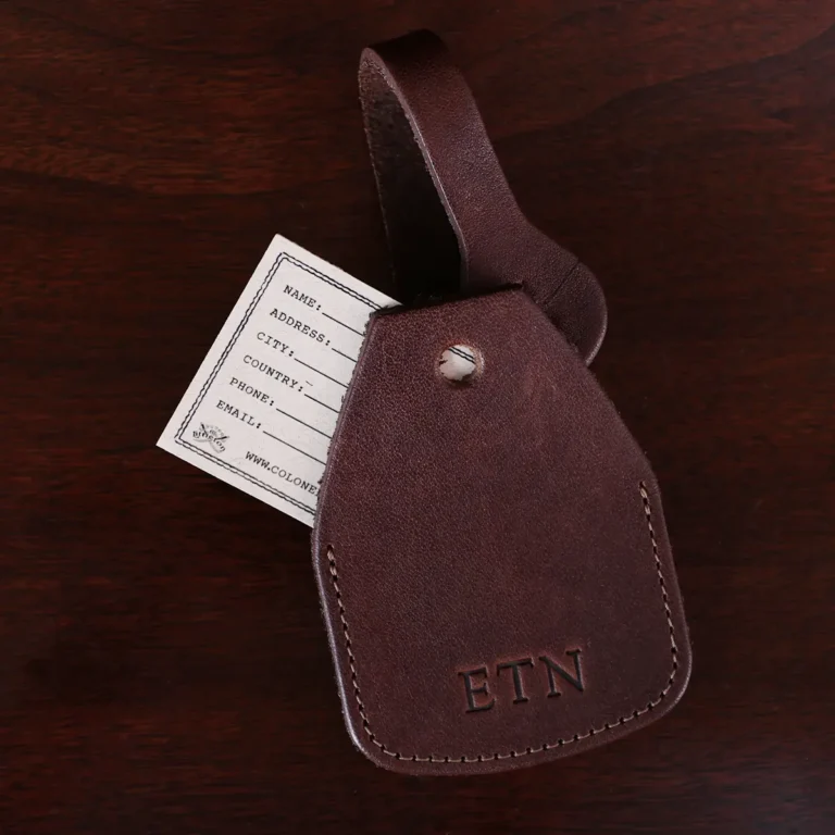 no14 leather vintage brown luggage tag with stamped personalization - open - on wood table and dark background