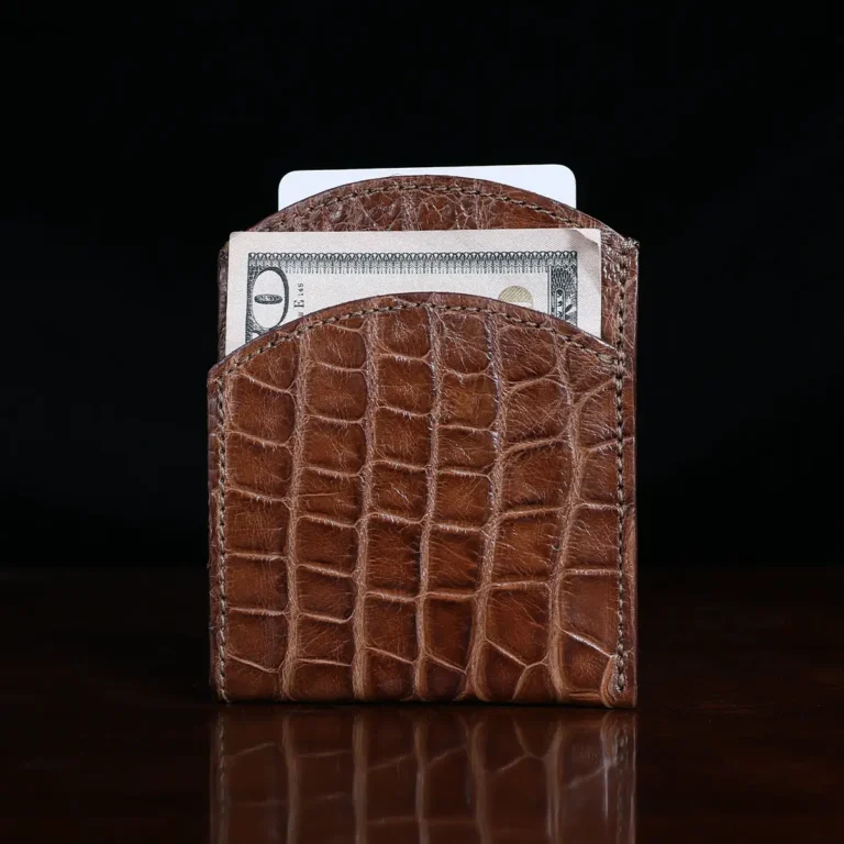 Front pocket wallet in brown American Alligator - ID 003 - front view with money on black background