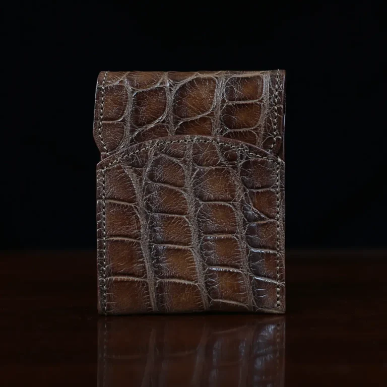 Front pocket wallet with flap in brown American Alligator - front view - 001 - on wood table with a dark background