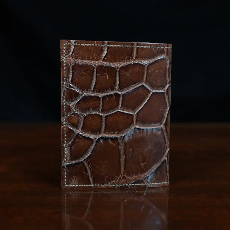 No. 2 card wallet in Vintage Brown American Alligator - ID 001 - back view on a wood table and dark background