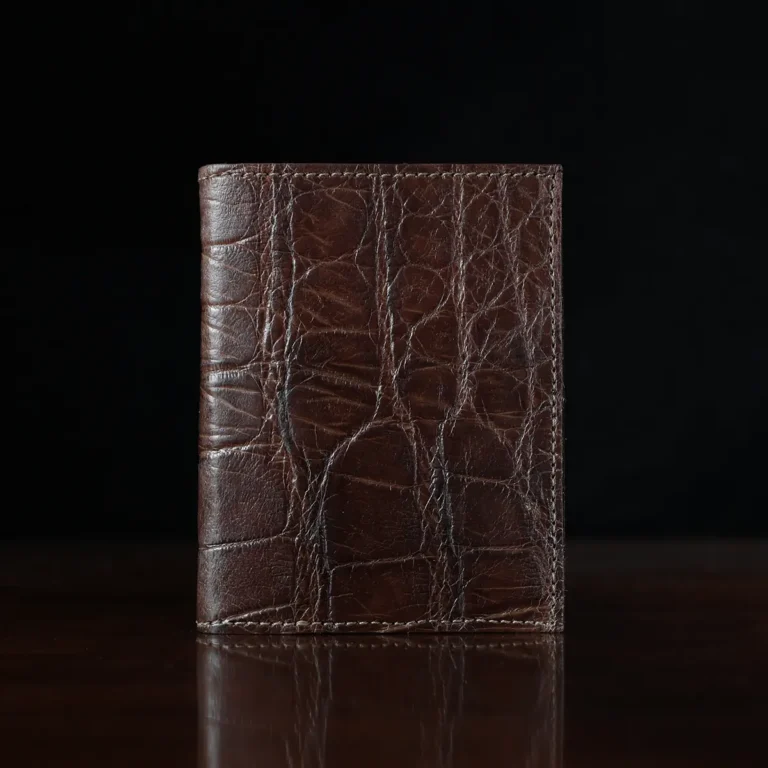 No. 2 card wallet in Vintage Brown American Alligator - ID 001 - front view on a wood table and dark background