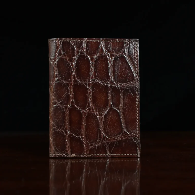 No. 2 card wallet in Vintage Brown American Alligator - ID 001 - front view on a wood table and dark background
