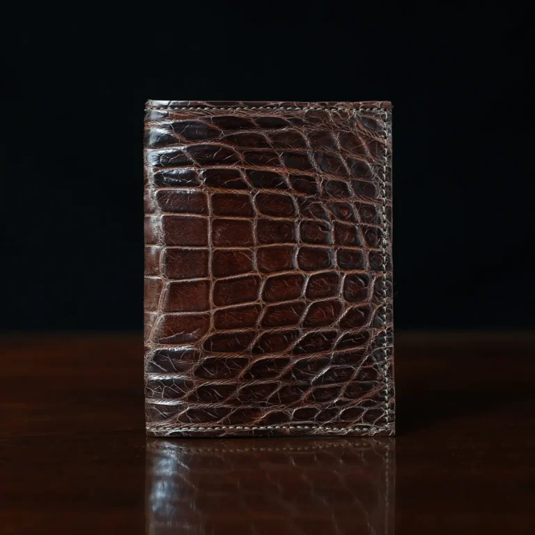 No. 2 card wallet in Vintage Brown American Alligator - ID 001 - front view on a wood table and dark background