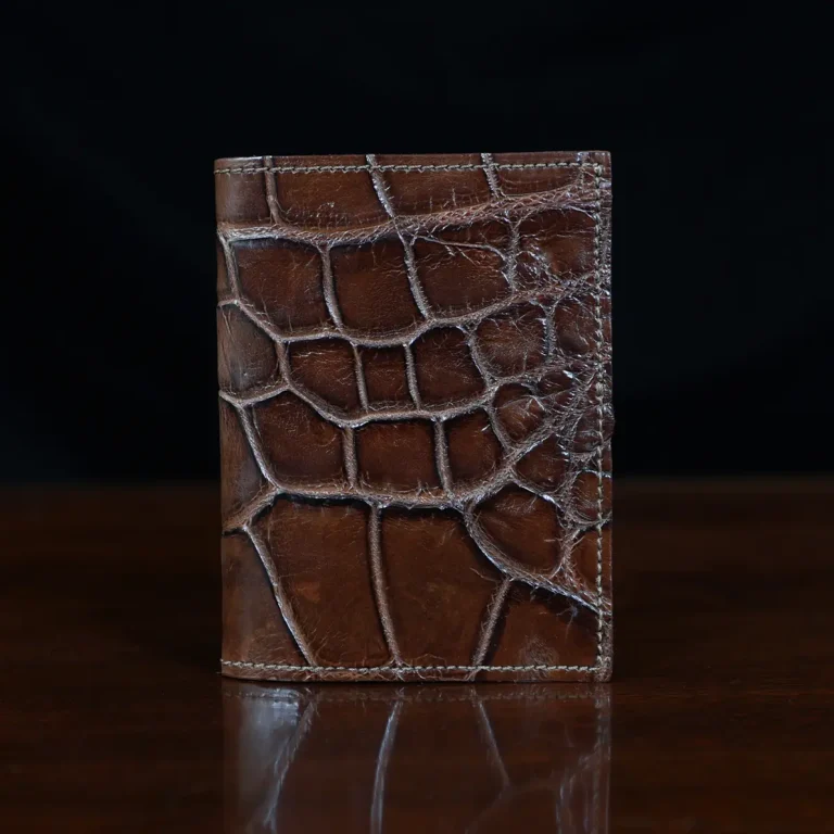 No. 2 card wallet in Vintage Brown American Alligator - ID 001 - front view on a wood table and dark background