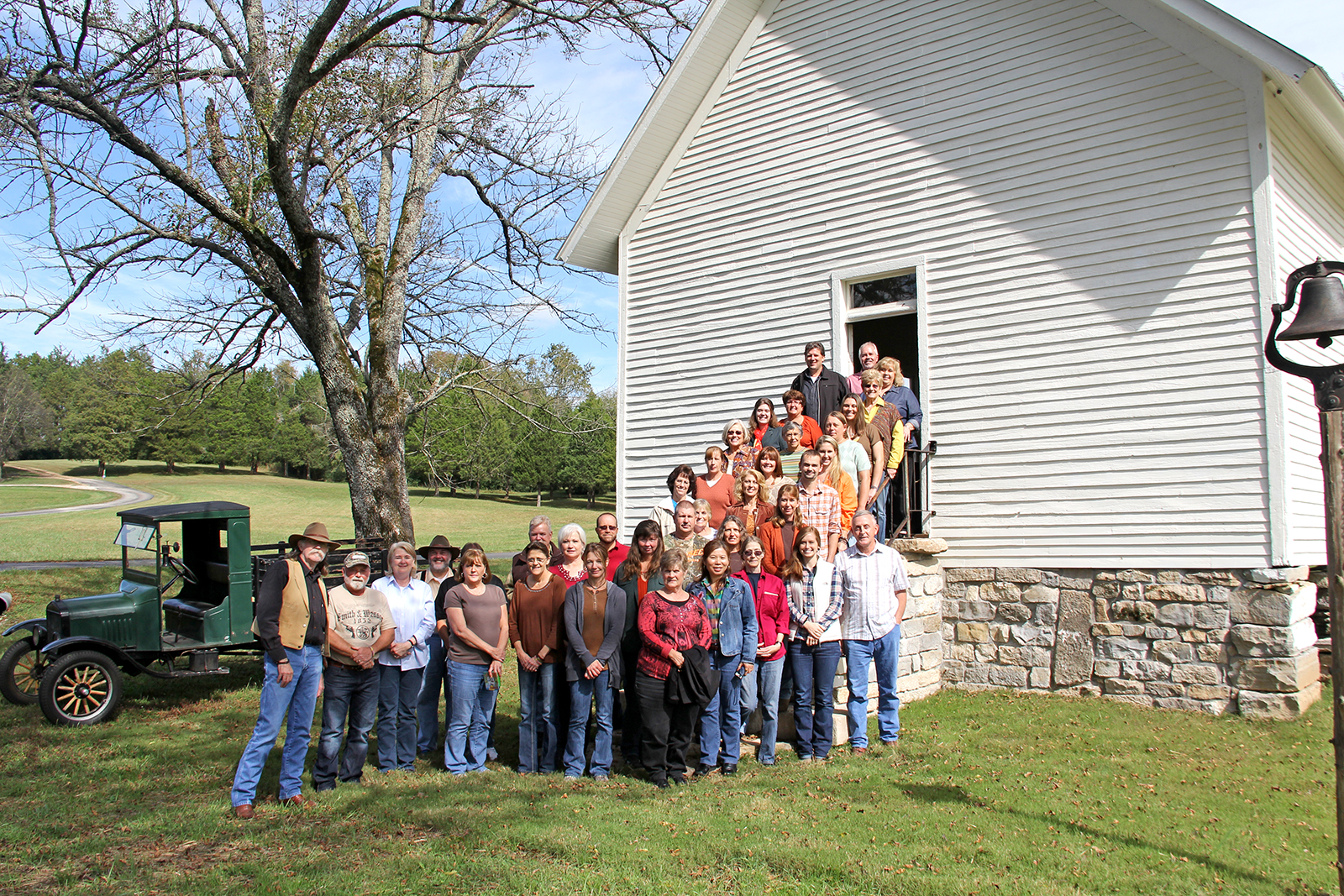 Colonel Littleton company photo standing in front of the one-room schoolhouse on Foxfire Farm in Lynnville, TN
