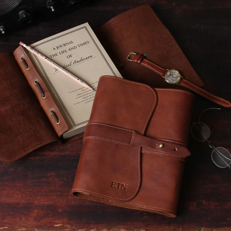 American Steerhide leather journal front and open view sitting on table with wrist watch, pencil and reading glasses