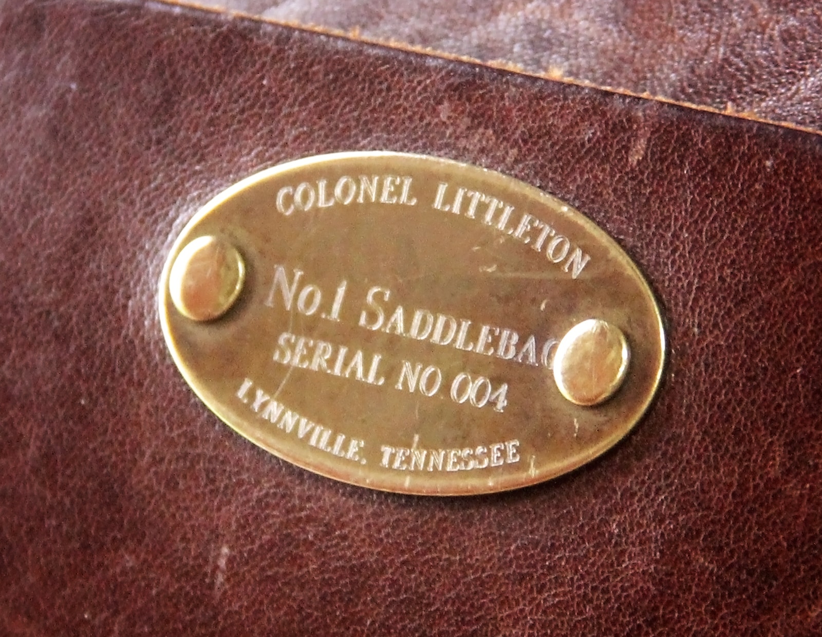 Close up shot of the plate on Col.'s No. 1 Saddlebag Briefcase. serial number 004
