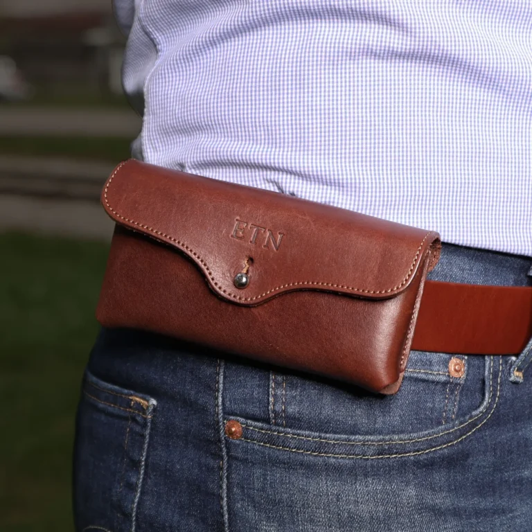 a man wearing the vintage brown leather phone holster on his belt