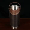 The front view of a leather tumbler sleeve show casing tobacco brown american buffalo and american alligator trim.