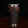 The side view of a leather tumbler sleeve show casing tobacco brown american buffalo and american alligator trim.