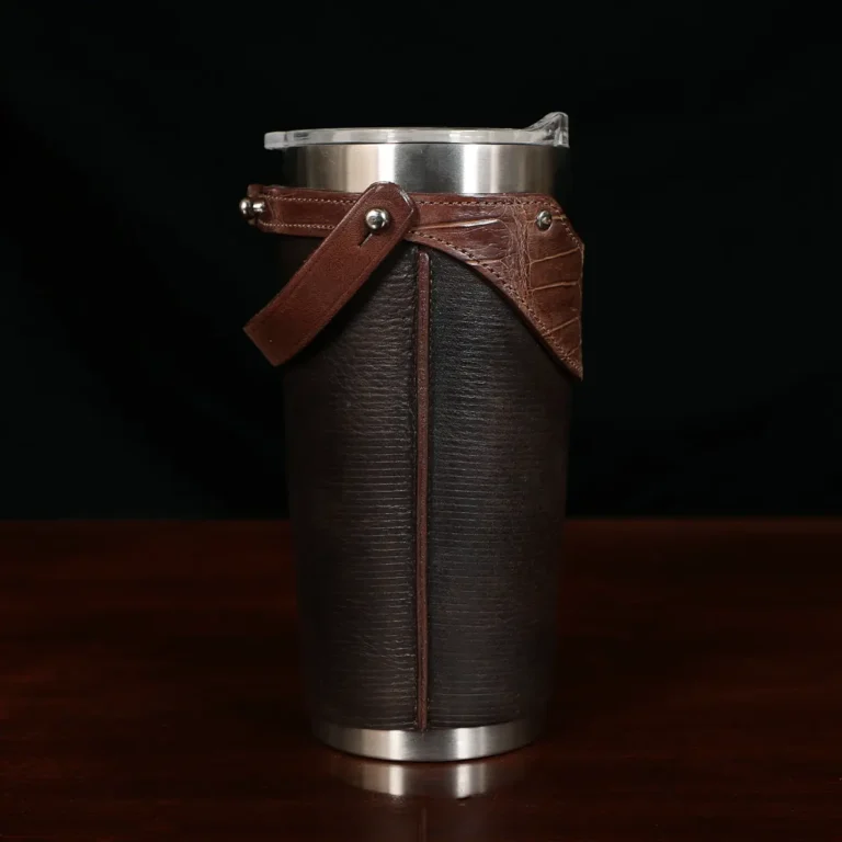 The side view of a leather tumbler sleeve show casing tobacco brown american buffalo and american alligator trim.