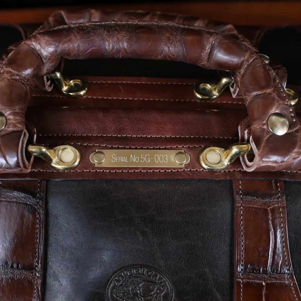 no 5 grip in tobacco buffalo with brown american alligator trim - front view of serial number - on a wood table with black background - ID 003