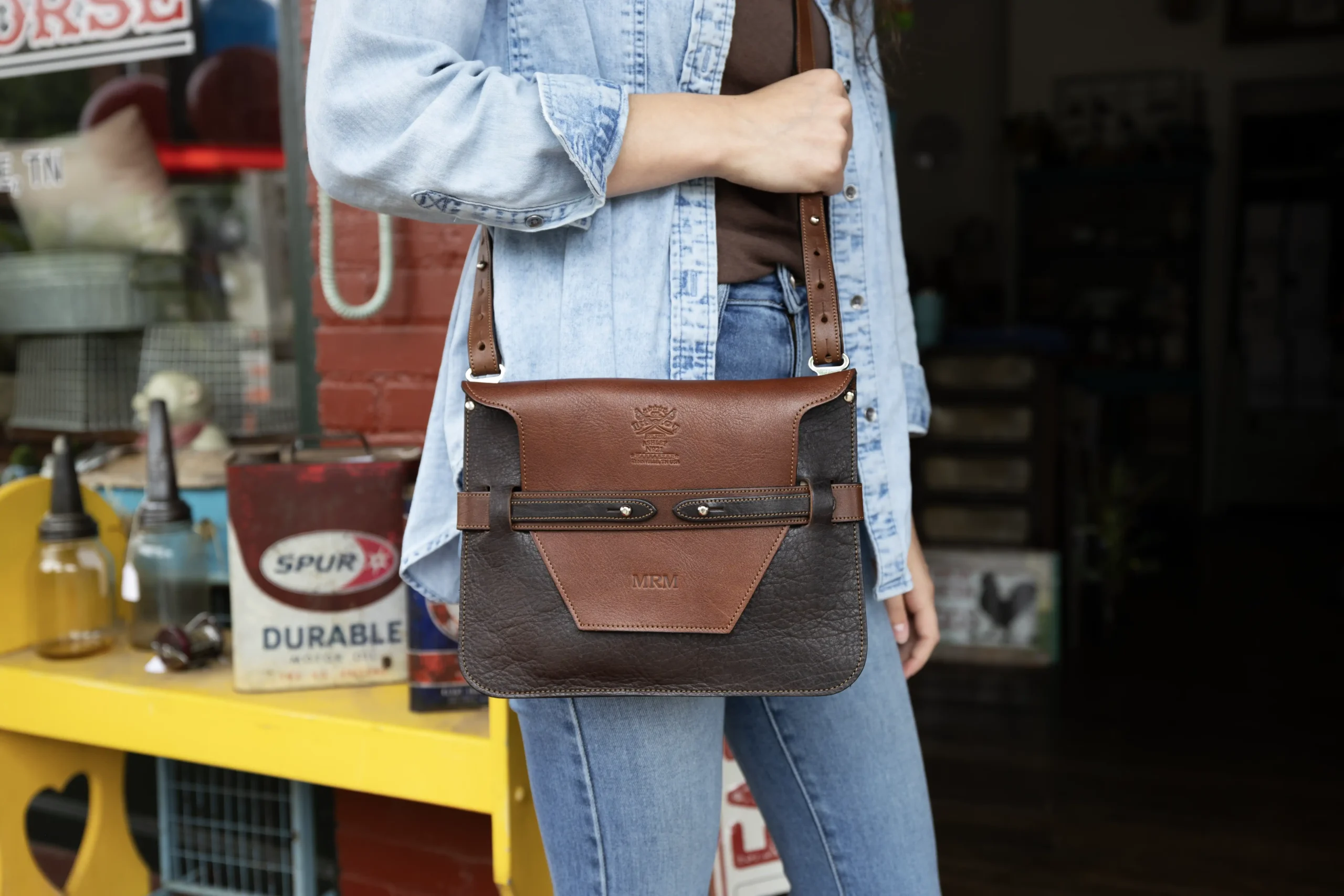ashley handbag made of two-tone brown buffalo and steerhide leather - front view shown with a woman wearing it