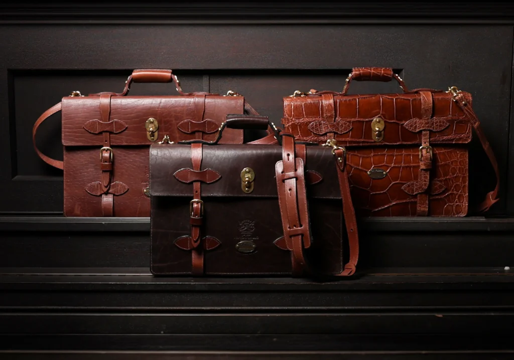 three of Col Littleton navigator briefcases in a lifestyle format