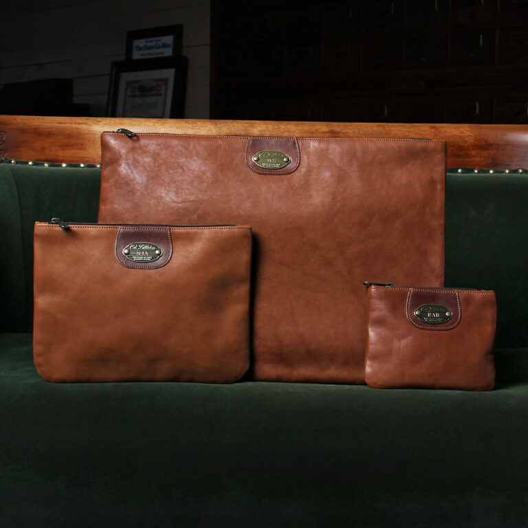 small-medium-large leather zip its on a green couch