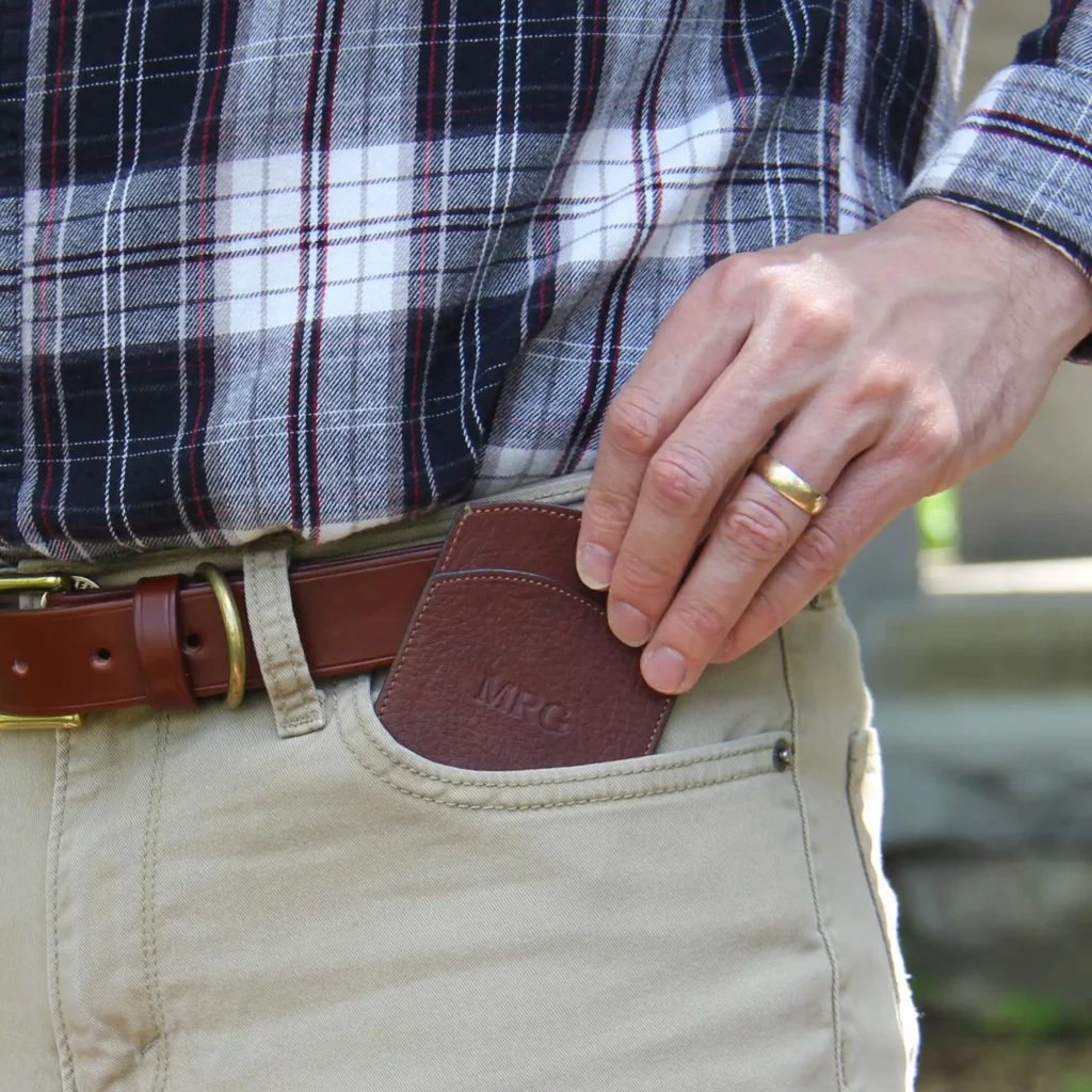 man pulling front pocket wallet from pocket