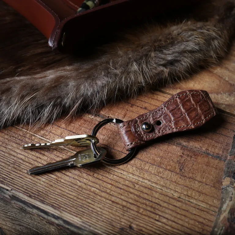 front side of No. 6 American Alligator Key Ring shown on a rustic table with keys