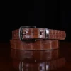 No. 4 Belt in American Alligator - XLarge - CB4XL-A-002 - coiled front view on a wooden table