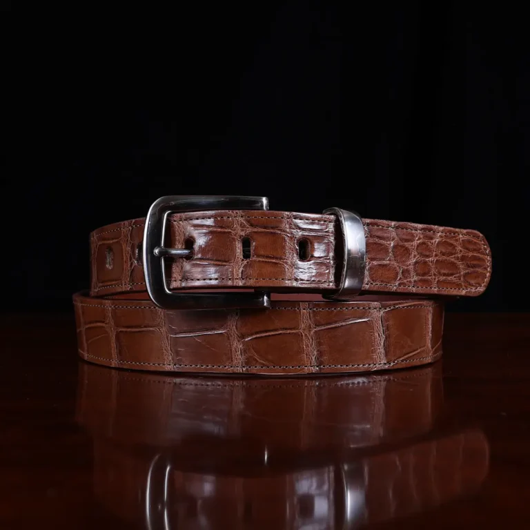 No. 4 Belt in American Alligator - X-Large - ID 001 - coiled front view on a wooden table with black background