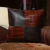 front of two tone leather pillow -tobacco buffalo- american alligator- sitting on couch - 001