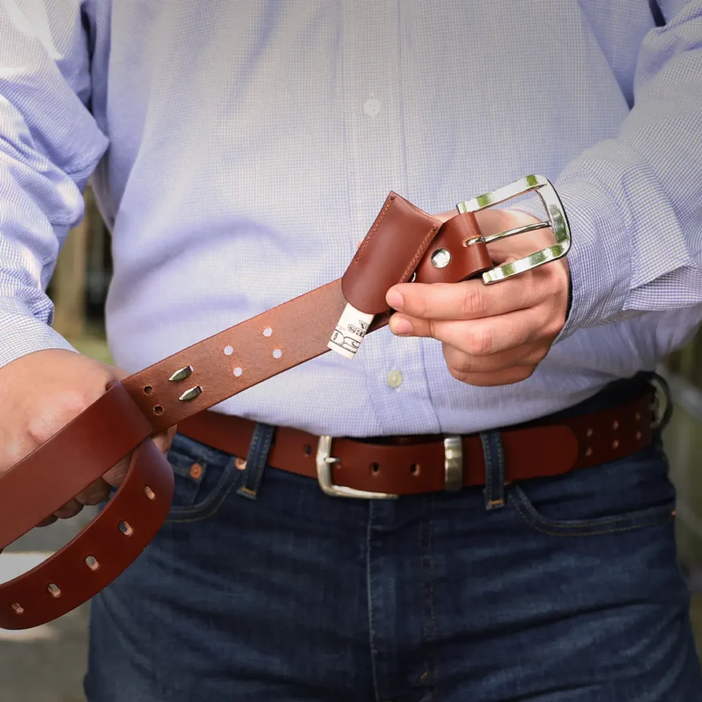 Man holding No. 4 Belt in Vintage Brown with a secret money sleeve