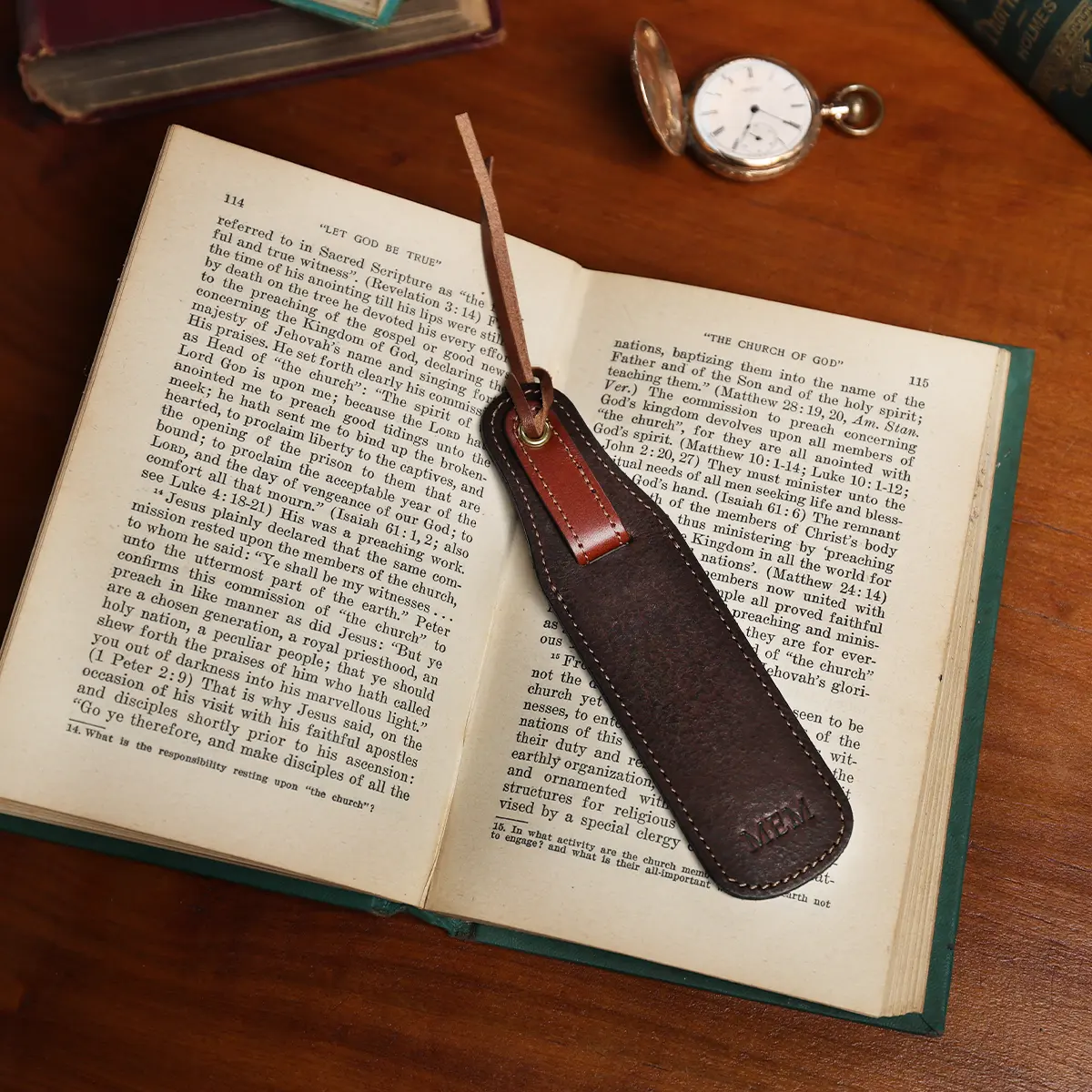 tobacco buffalo leather bookmark with secret pocket - front view on book with pocket watch