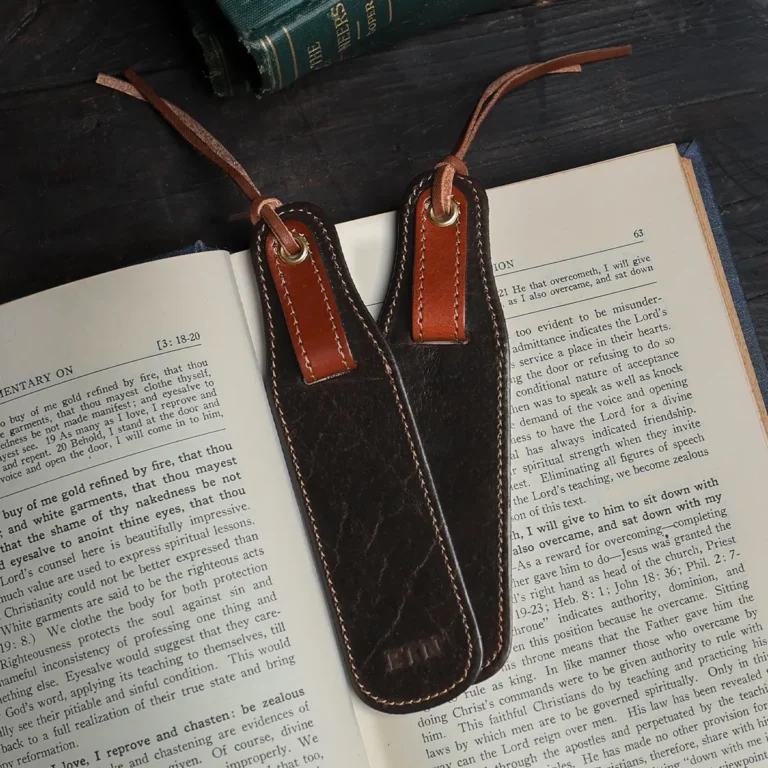 set of 2 tobacco buffalo leather bookmarks on a book