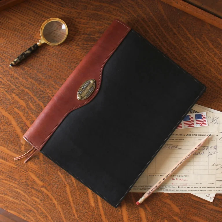 leather journal in black sitting on a vintage desk