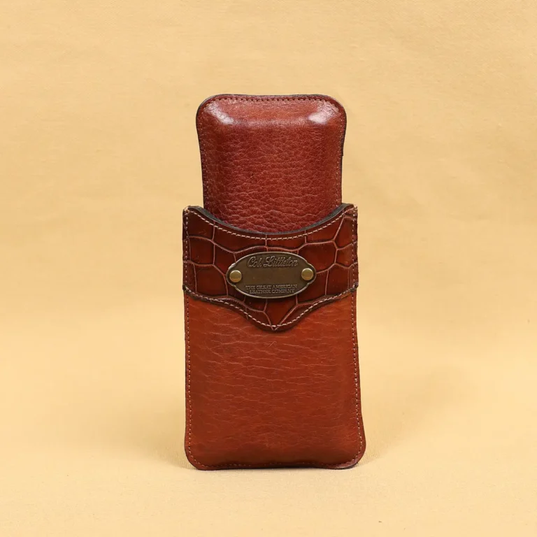 The front side of a leather cigar case in American Buffalo and American Alligator trim with brass hardware.