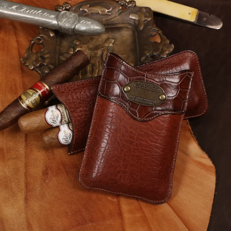 The front side of a leather cigar case in American Buffalo and American Alligator trim with brass hardware.