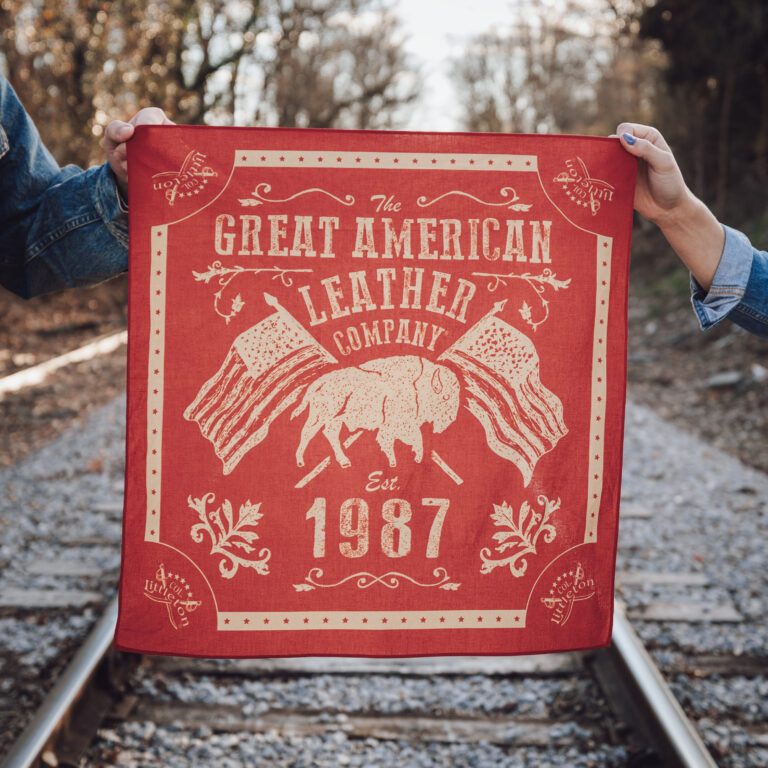 two people holding a colonel littleton bandana