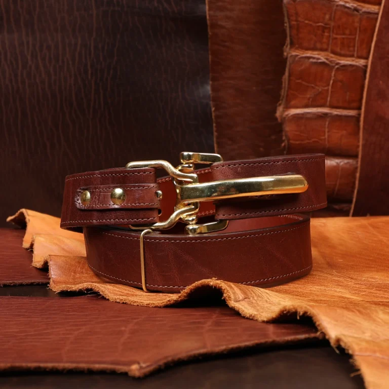 Front view of the cinch belt made from American Steerhide, trimmed with Alligator featuring brass hardware.