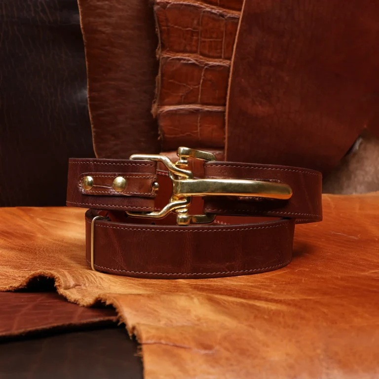 Front view of the cinch belt made from American Steerhide, trimmed with Alligator featuring brass hardware.